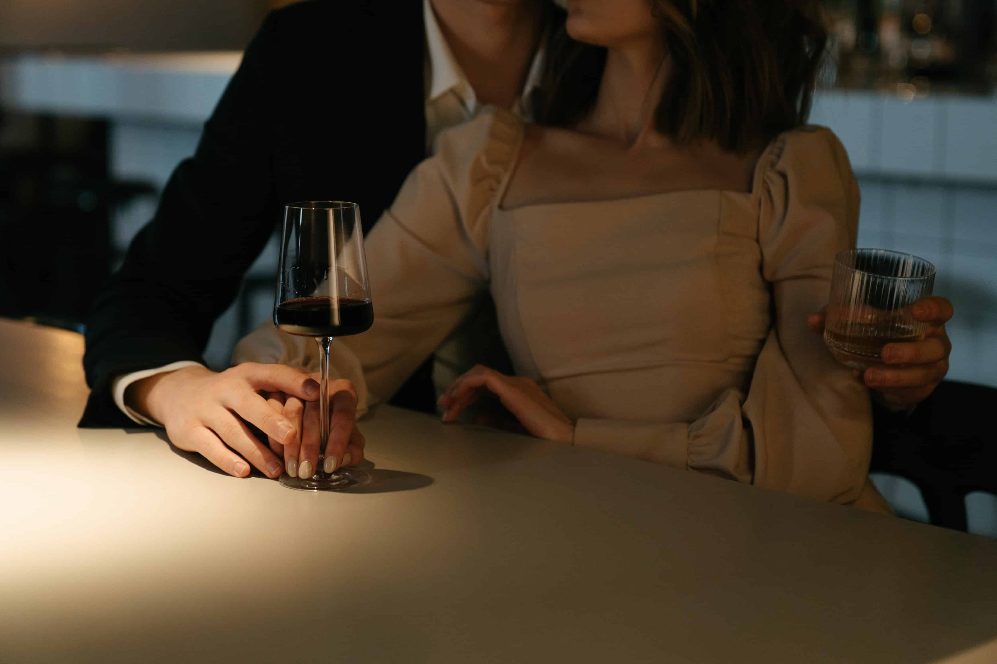 well dressed couple on a date drinking wine